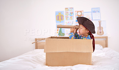 Buy stock photo Young, boy or box for pirate with creativity in home, playing game with telescope. Male child or cardboard or bedroom at house with youth, captain for halloween in fantasy ocean or apartment with fun