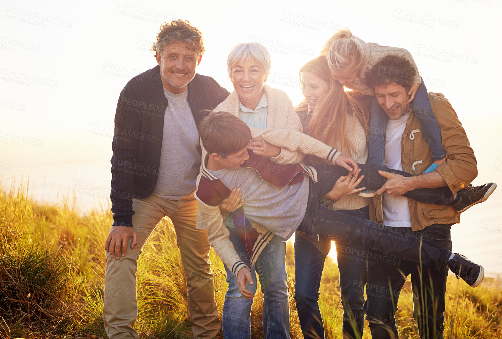 Buy stock photo Grandparents, parents and children fun portrait in nature, spring in countryside. Exercise, kids and generations playing with child, happy in field on vacation with family together in calm outdoors