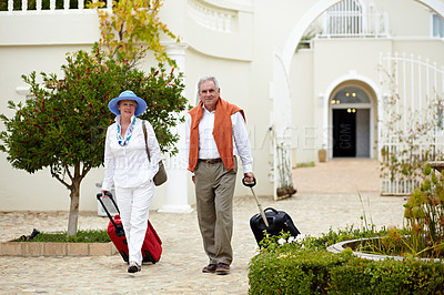 Buy stock photo Hotel, vacation and elderly couple walking with suitcase in a holiday location happy in retirement and travel together. Bag, smile and senior people on a journey or man and woman walk in happiness