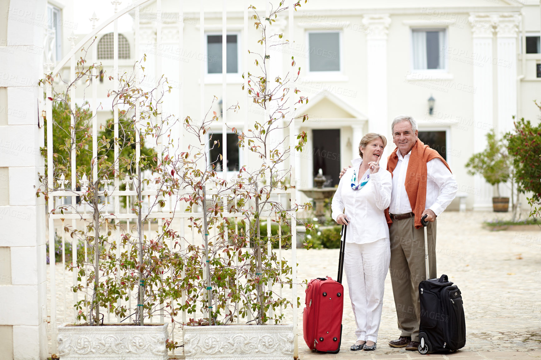 Buy stock photo Travel, hotel and senior couple relax on vacation with suitcase in a holiday location happy in retirement together. Bag, smile and elderly people on a journey or man and woman pointing in happiness
