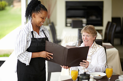 Buy stock photo Waitress, service and senior woman in a restaurant for breakfast or lunch at a hotel with a menu and choice of food. Friendly, order and elderly person happy on vacation or holiday for hospitality