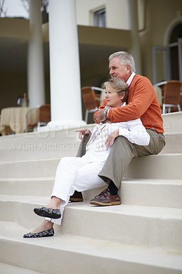 Buy stock photo Hug, love and an old couple on hotel steps for travel, vacation or tourism in luxury accommodation. Retirement, relax or hospitality with a senior man and woman hugging on the staircase of a resort