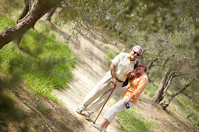 Buy stock photo A senior couple walking together along a forest trail