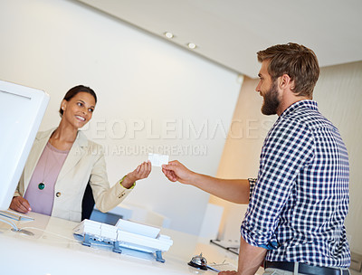 Buy stock photo Cropped shot of a handsome young man checking in to a hotel