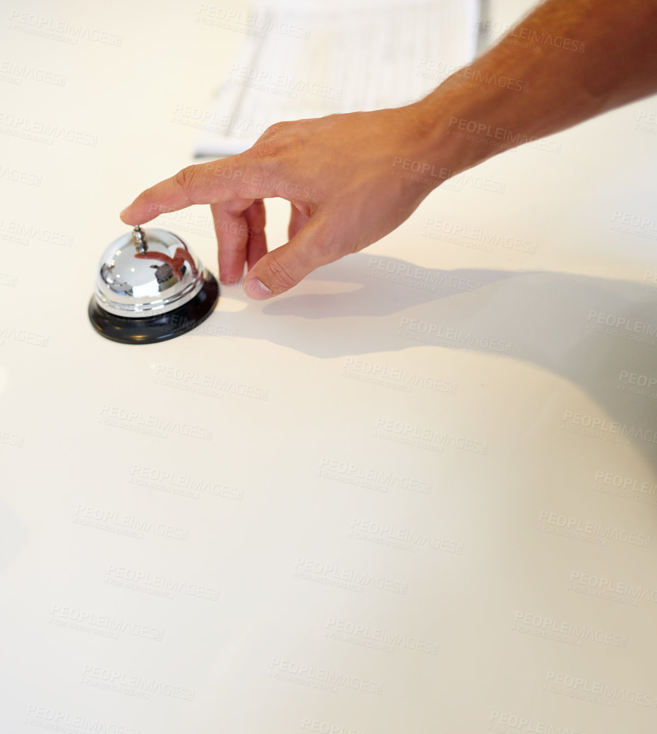 Buy stock photo Shot of a hand ringing a bell at a hotel check in counter