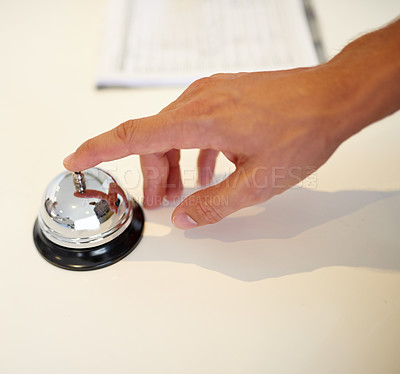 Buy stock photo Shot of a hand ringing a bell at a hotel check in counter