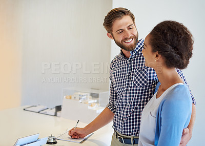Buy stock photo Cropped shot of a young couple standing at the hotel reception desk