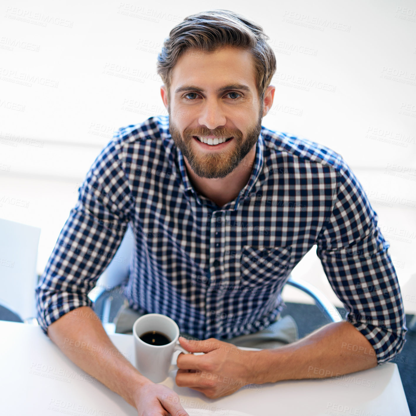 Buy stock photo Portrait of a handsome businessman sitting with a cup of coffee at his office desk