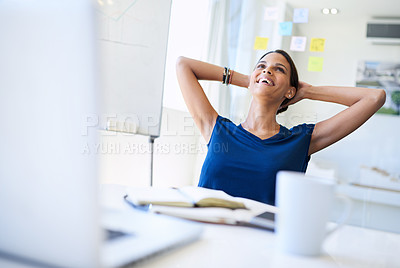 Buy stock photo An attractive young businesswoman sitting with her hands behind her head at her office desk