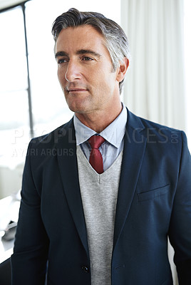 Buy stock photo Shot of a mature businessman looking thoughtful in the workplace