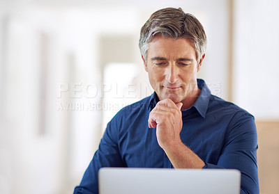 Buy stock photo Shot of a mature man using a laptop at home