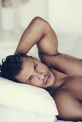 Buy stock photo Man, face relax shirtless in bed and in bedroom of his home. Confident, serious and topless male model laying with hot guy look in the morning for skincare or body wellness after a wake up