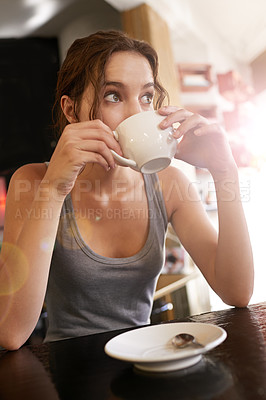 Buy stock photo Cropped shot of a young woman drinking coffee at a cafe