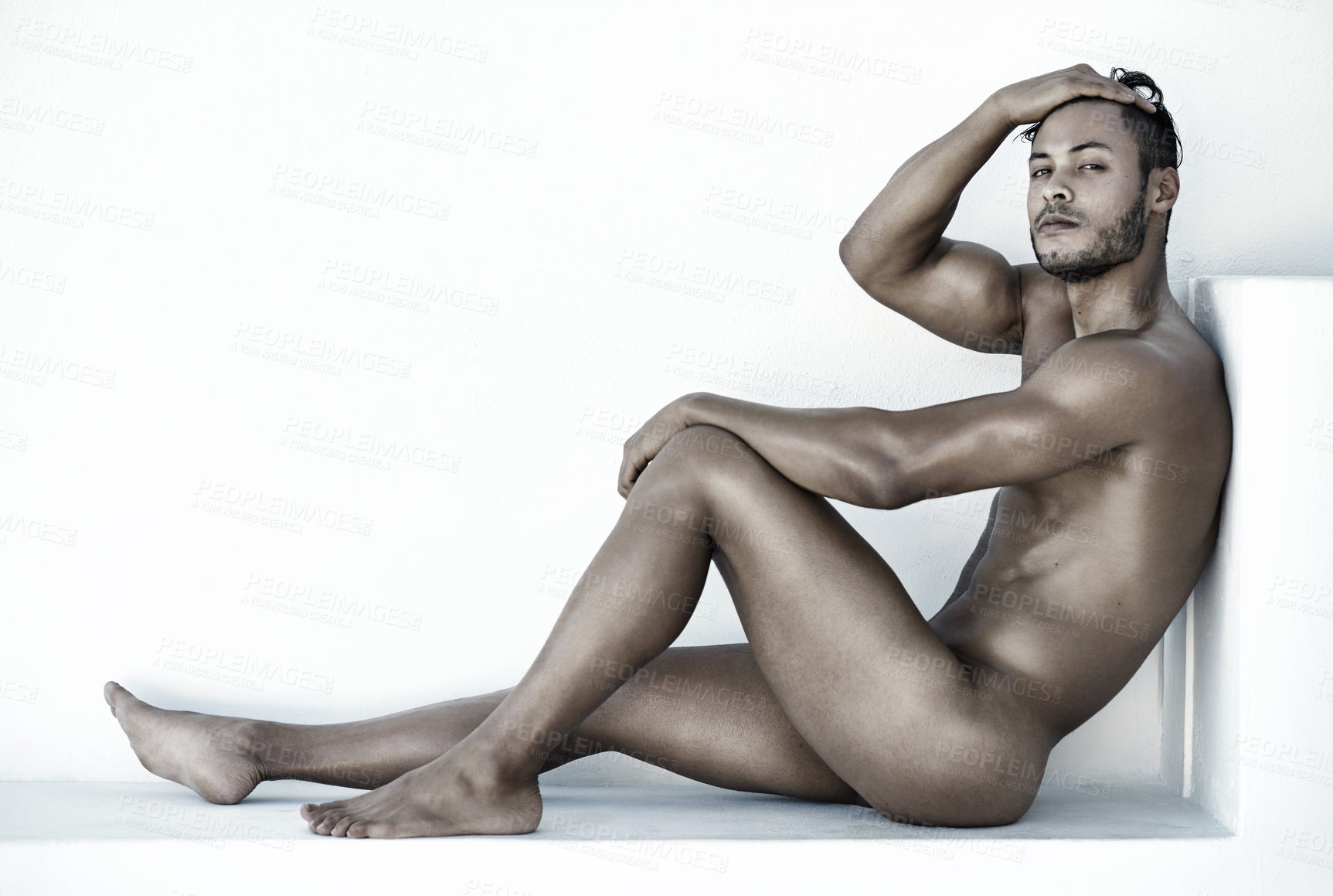 Buy stock photo Portrait, nude and a sexy man sitting on the floor of a studio against a white background for natural body care. Fitness, skin and wellness with a handsome young male model posing naked for health