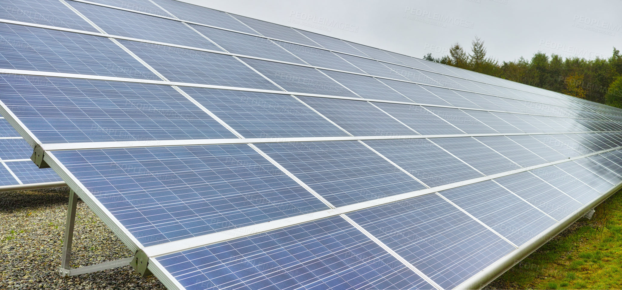 Buy stock photo Solar power station in Denmark. Photovoltaic solar cell panels as renewable energy source. Blue solar panels generating electricity in solar power station, alternative energy from nature