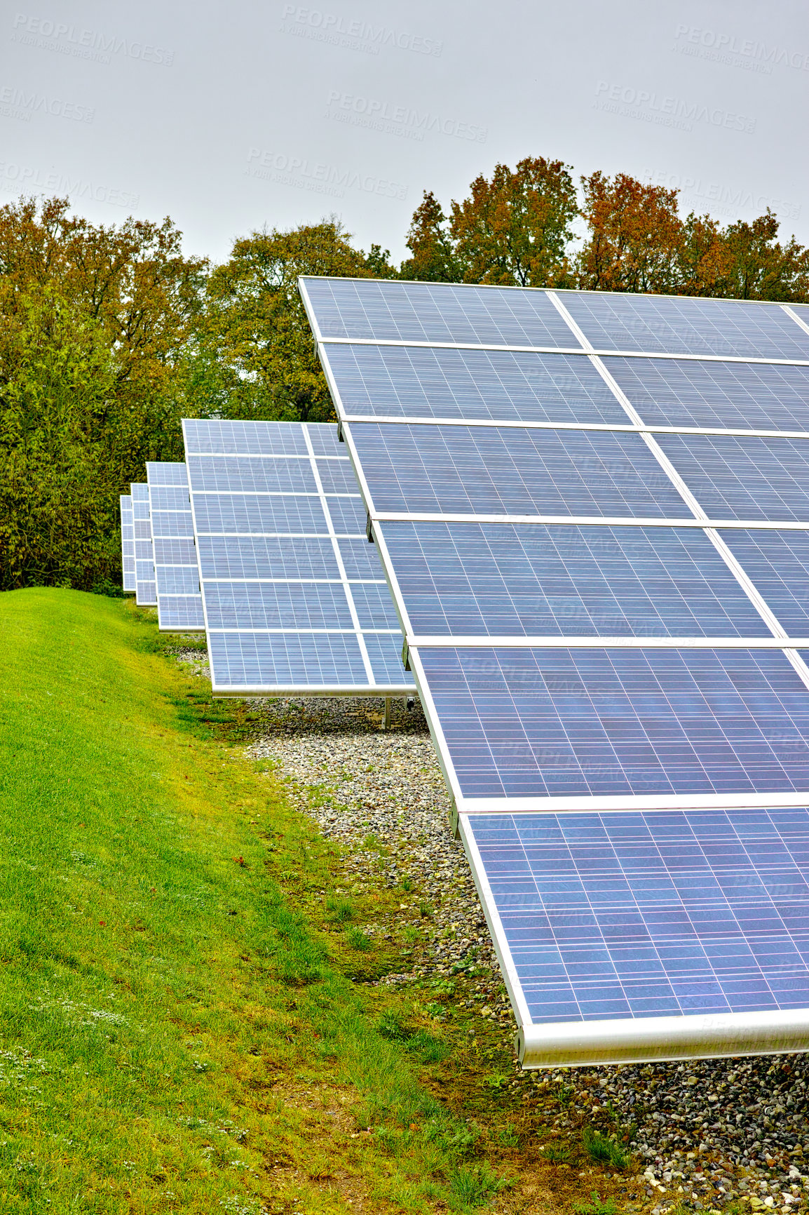 Buy stock photo Solar power plant. A renewable energy source producing sustainable clean solar energy from the sun. Photovoltaic panels generating alternative energy from nature on an off the grid farm in Denmark