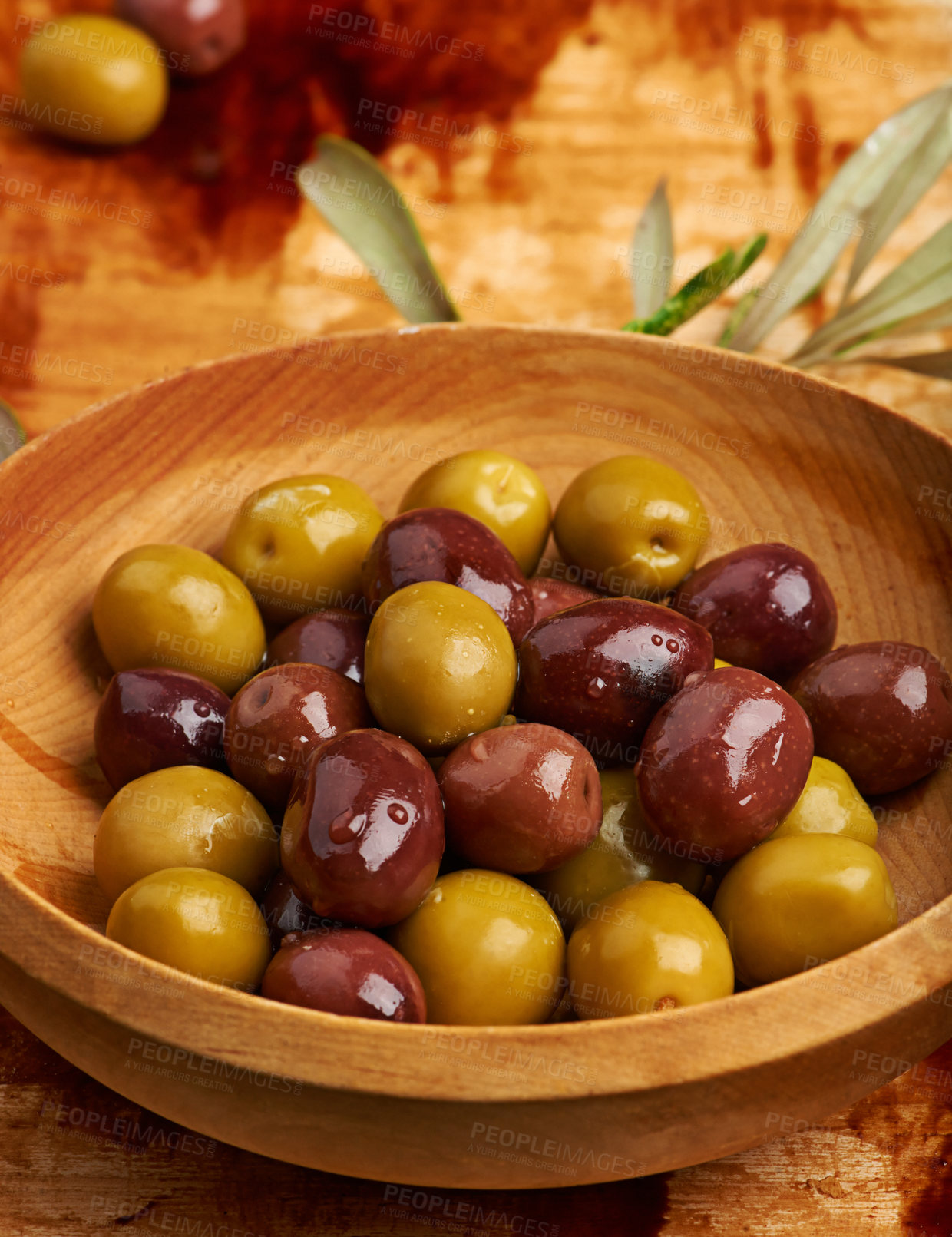 Buy stock photo Olive, bowl and fresh for cooking in kitchen with Greek food, healthy salad and cocktail ingredient. Nutrition, table top and fruit snack on wood surface for green, organic oil and source of iron