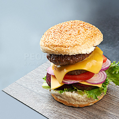 Buy stock photo Beef, burger and cheese on menu in restaurant with lettuce, tomato and onion on sesame bun in kitchen. Bbq, hamburger and fast food with meat and salad from fine dining diner for dinner or lunch