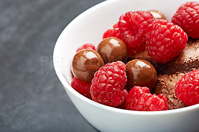 Buy stock photo Raspberry, chocolate and dessert on table top for health, wellness and nutrition in kitchen. Fruit, vegetarian and sugar for breakfast in home for morning, diet and organic candy or food on counter