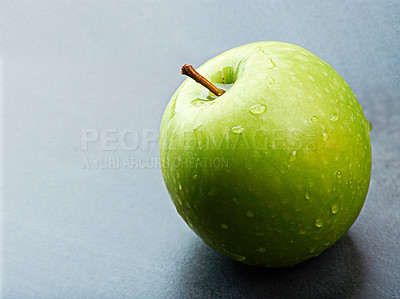 Buy stock photo Closeup, natural or apple for diet in kitchen of home on counter for food, vitamin c or healthy nutrition. Vegan, background and wet fruit with green color in house for meal, detox and snack minerals