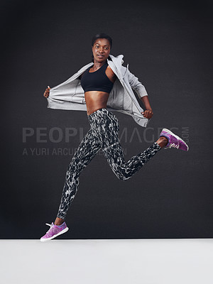 Buy stock photo Studio shot of a beautiful young woman working out against a black background