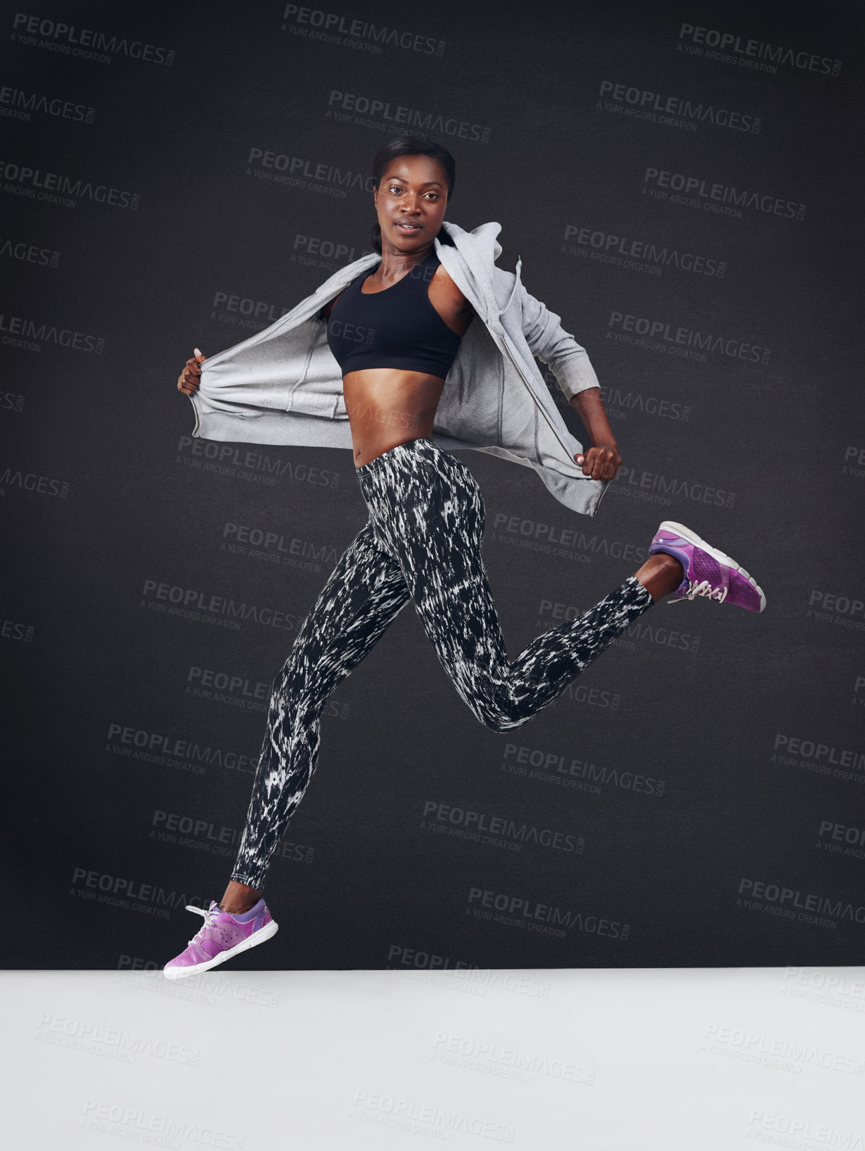 Buy stock photo Studio shot of a beautiful young woman working out against a black background