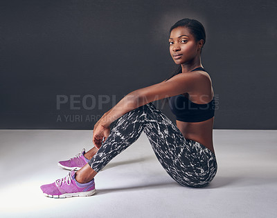 Buy stock photo Studio shot of a beautiful young woman resting after a workout against a black background