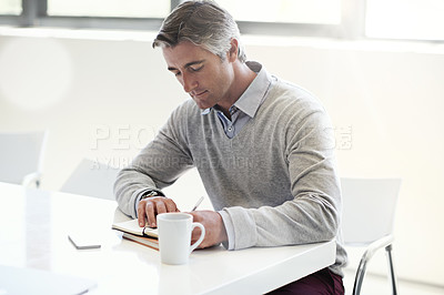 Buy stock photo Shot of a businessman at work in an office