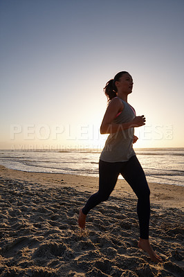 Buy stock photo Silhouette of a young woman running on the beach at sunset