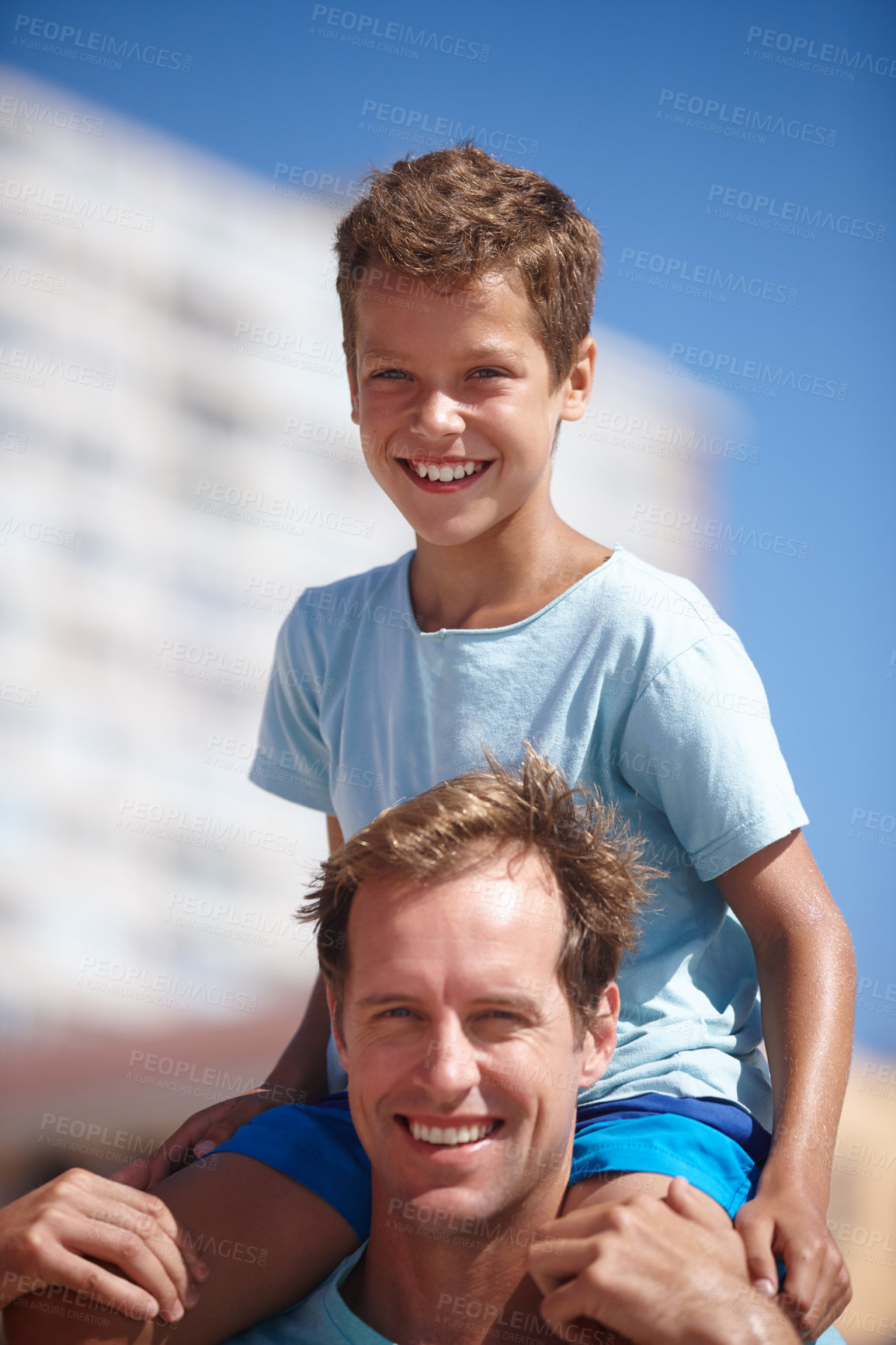 Buy stock photo Shot of a father carrying his son on his shoulders in the outdoors