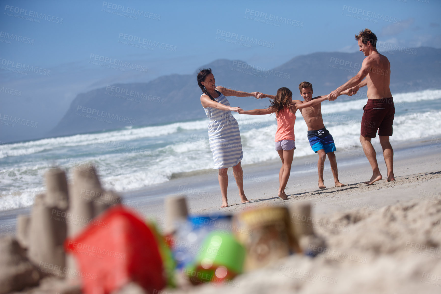 Buy stock photo Shot of a happy family being playful at the beach