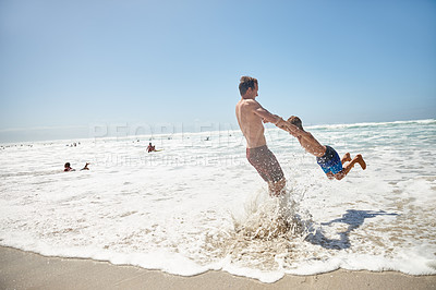 Buy stock photo Shot of a father and his son having fun at the beach