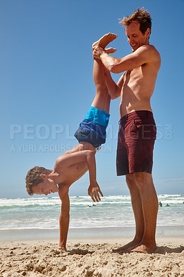 Buy stock photo Shot of a father and his son having fun at the beach