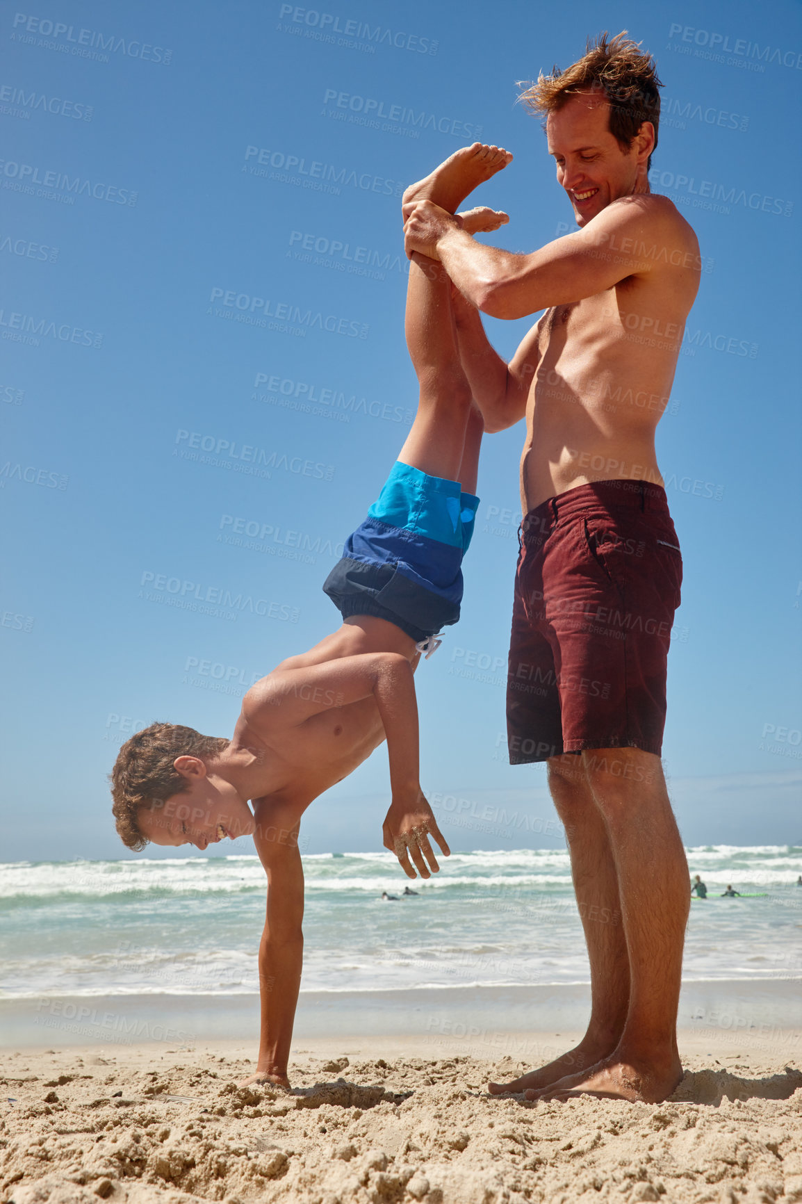 Buy stock photo Shot of a father and his son having fun at the beach