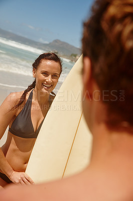 Buy stock photo Shot of a couple surfing together at their favourite beach