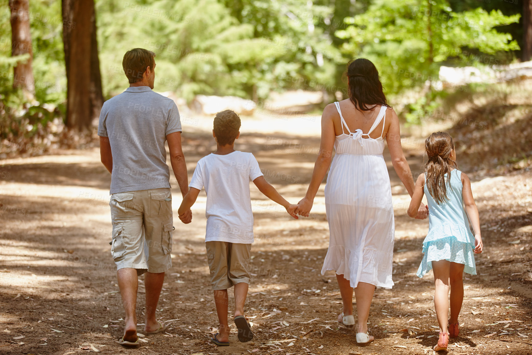 Buy stock photo Shot of a happy family spending quality time together in the forest