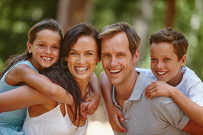 Buy stock photo Shot of a happy family spending quality time together in the forest