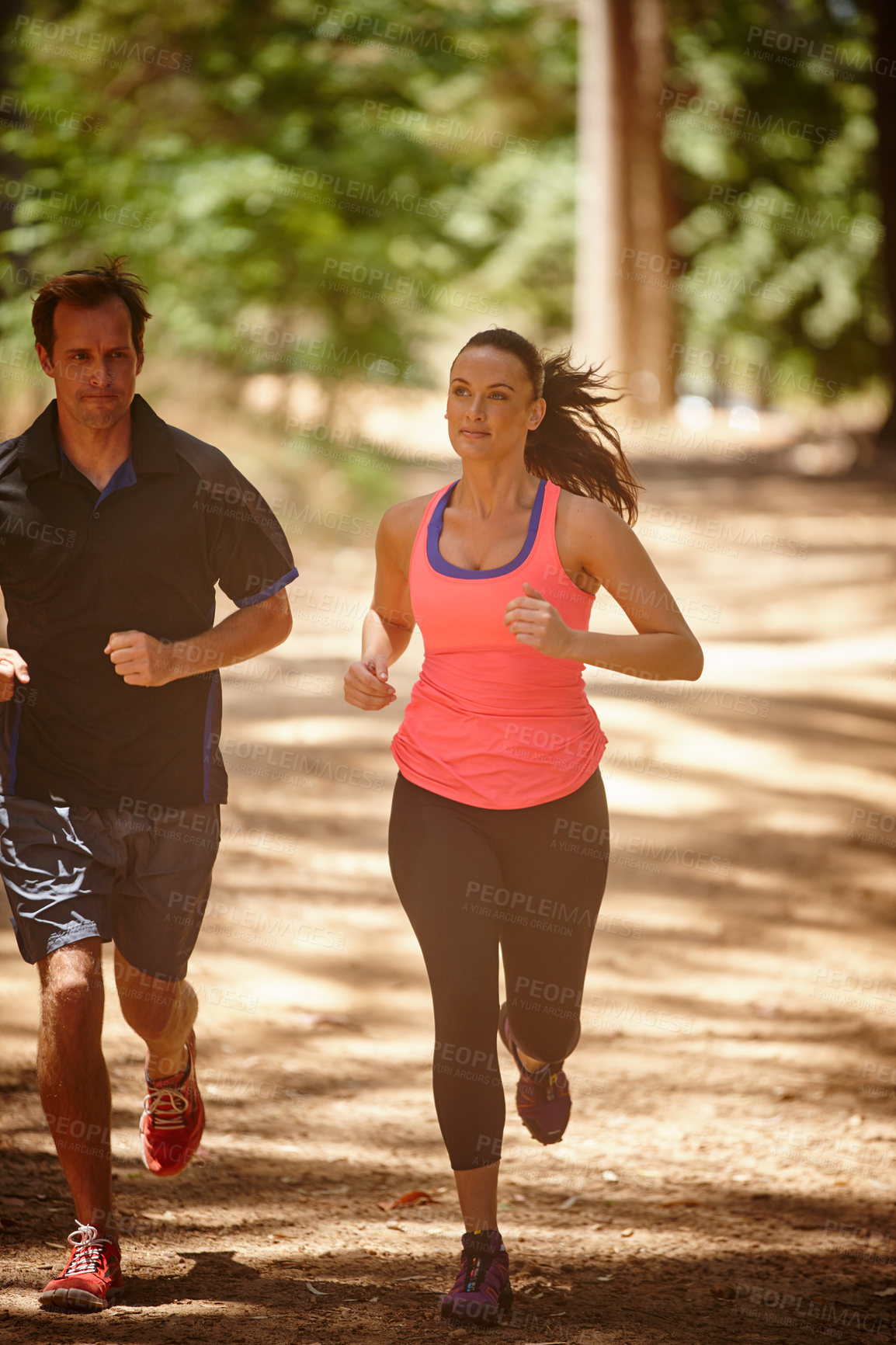 Buy stock photo Full length shot of a couple jogging in the forest