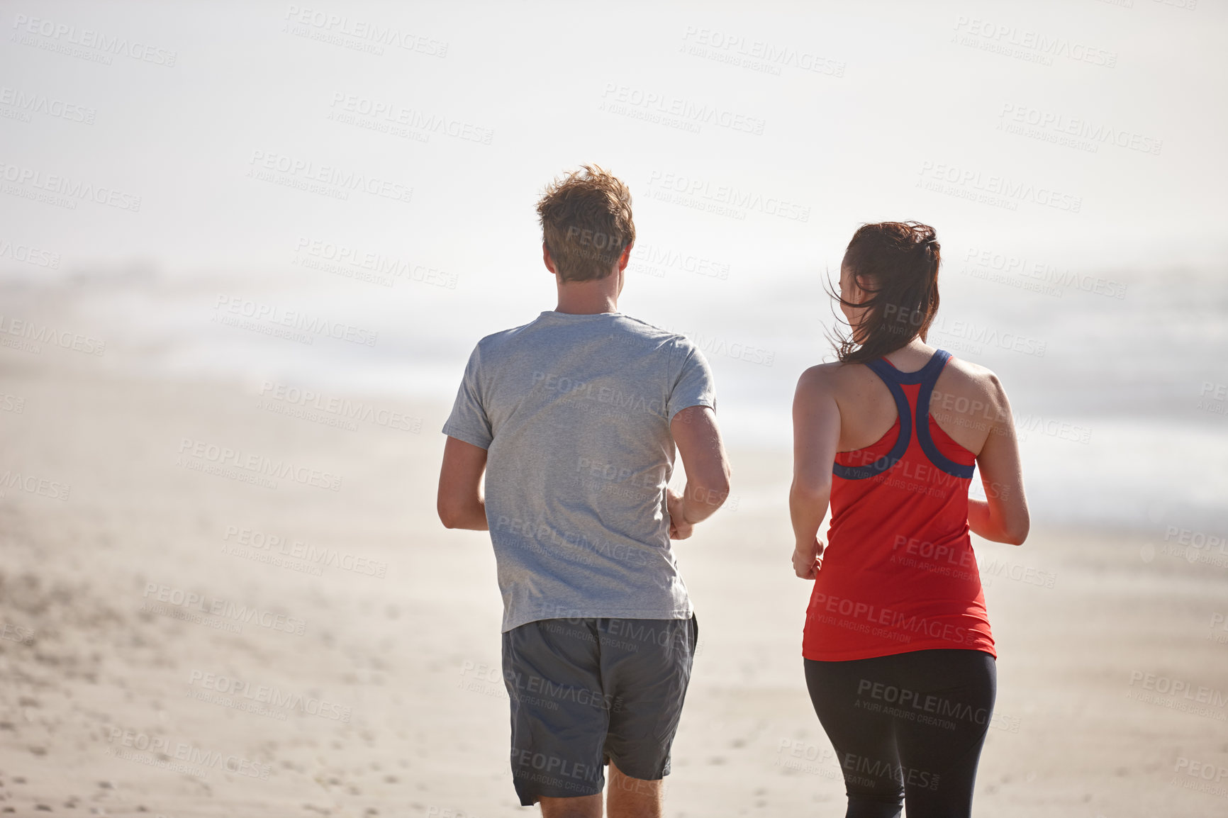 Buy stock photo Shot of a young couple exercising outdoors