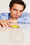 Man playing with toy car thinking about new business strategy