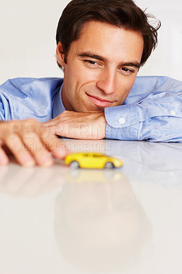 Buy stock photo Man, face or business with car or toy for thinking, finance or vehicle loan by table in corporate office. Person, happy or dream motor with thoughtful, ideas and contemplating for transport insurance