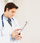 Young doctor with stethoscope looking at medical reports