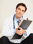 Thoughtful doctor holding medical report at hospital