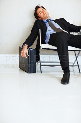 Buy stock photo Business man, sleeping and case in lobby, chair and fatigue from travel, overworked or burnout in suit. Entrepreneur, briefcase and tired with rest, exhausted or luggage for corporate job with stress