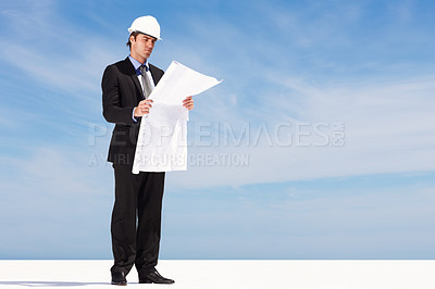 Buy stock photo Industry, blueprint and man engineer by blue sky on building rooftop for planning for maintenance. Career, mockup space and professional male industrial worker with architecture drawing for project.