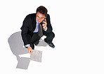 Business man using cellphone while sitting isolated on white