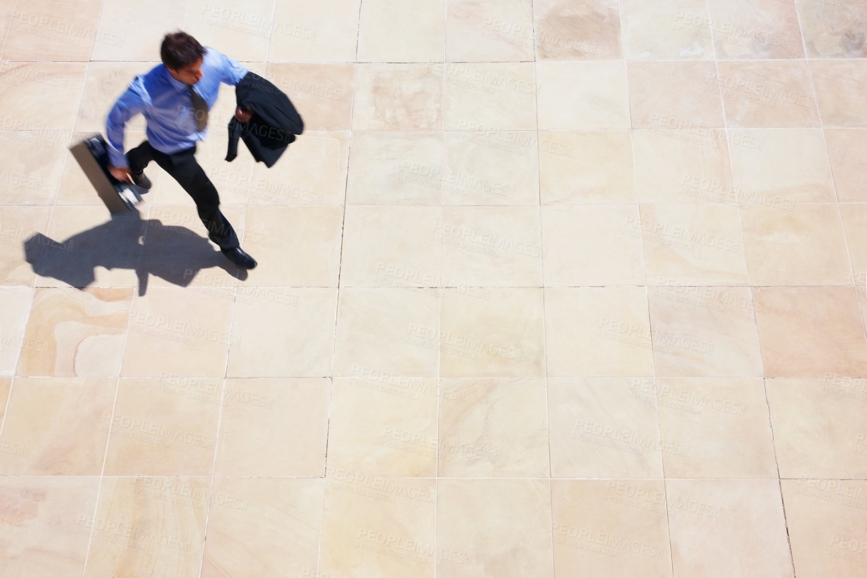 Buy stock photo Running, delay and a business man rushing to work for an appointment with a briefcase from above. Panic, fast and late with a professional employee in a hurry to get to his destination in the city