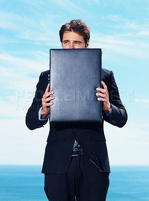 Buy stock photo Travel, anxiety and business man with briefcase at beach with fear, risk or lost in nature on blue sky background. Appointment, fail or entrepreneur at ocean with stress, afraid or abandoned at sea
