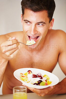 Buy stock photo Smile, eating and young man with fruit salad at his home for healthy breakfast or snack. Happy, wellness and male person from Canada enjoying yoghurt for meal in the kitchen at his modern apartment.