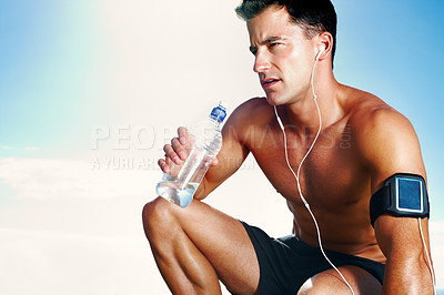 Buy stock photo Closeup of a handsome young man drinking water against the sky - Copyspace

